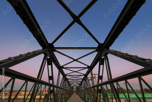 Pedestrian footbridge over railroad tracks in downtown Laramie, Wyoming at sunset
