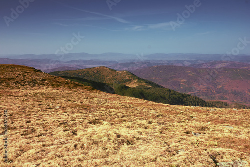 Climatic mountain landscape with blue sky and many mountains.