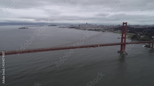 Golden Gate Bridge in San Francisco. Cloudy Day. Sightseeing Object, The Most Famous Bridge in California or USA. Alcatraz Island and Prison in Background. San Francisco Cityscape