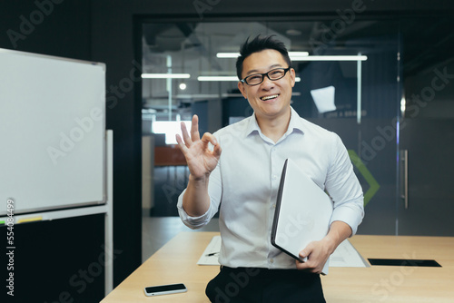 Photography Portrait of a young handsome Asian student, intern, assistant