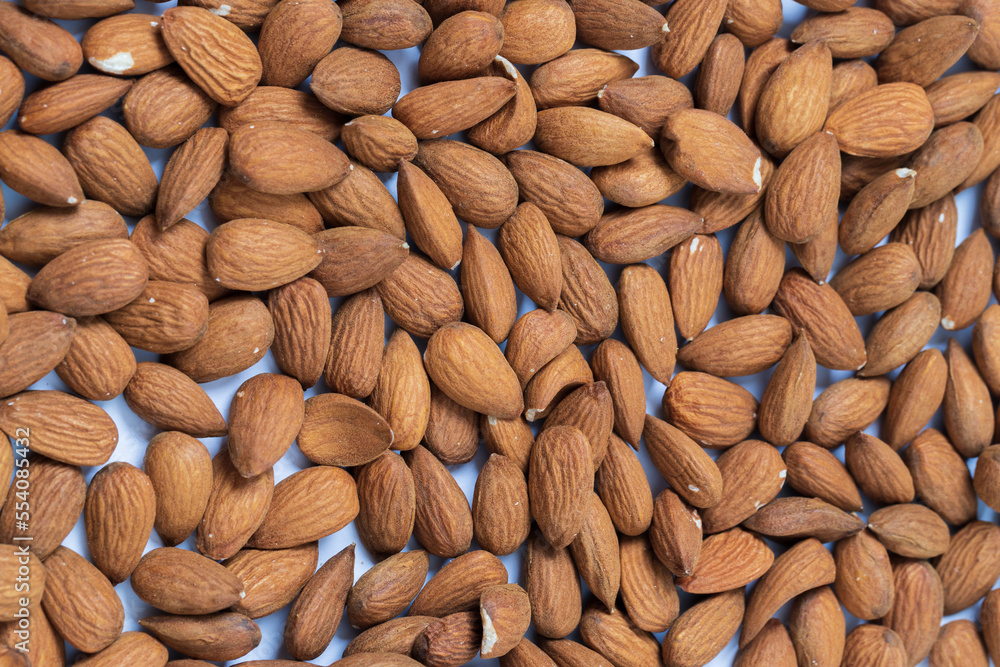 Unshelled almonds spread on a uniform surface Unshelled almonds spread on a uniform surface