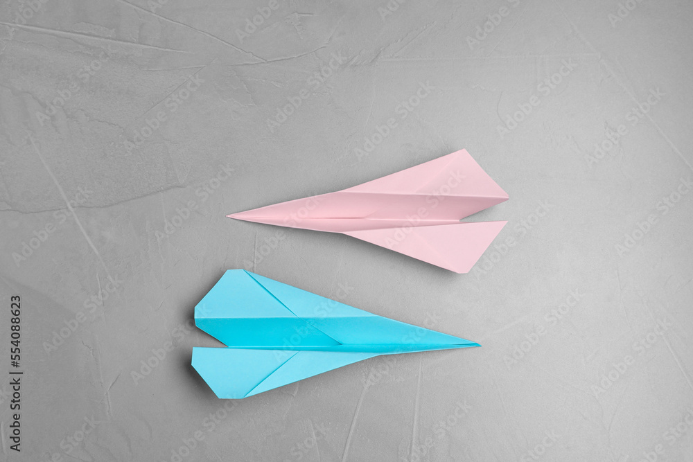Handmade paper planes on light grey table, flat lay Handmade paper planes on light grey table, flat lay