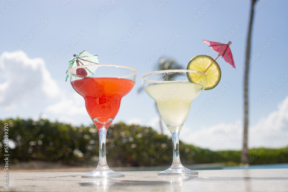 MARGARITAS. CHERRY AND LEMON DAISIES ON THE EDGE OF A POOL ON A SUNNY DAY MARGARITAS. CHERRY AND LEMON DAISIES ON THE EDGE OF A POOL ON A SUNNY DAY