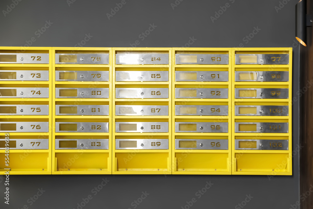 Many closed metal mailboxes with keyholes and numbers in post office Many closed metal mailboxes with keyholes and numbers in post office
