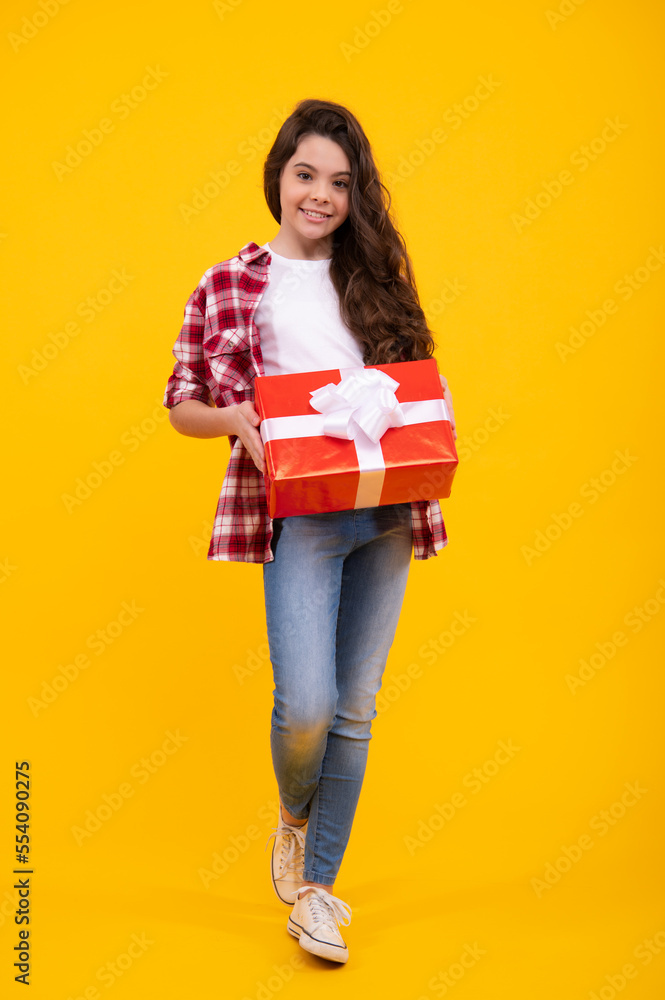 Teenager child with gift box. Present for holidays. Happy birthday, Valentines day, New Year or Christmas. Kid hold present box. Happy teenage girl, positive and smiling emotions. Teenager child with gift box. Present for holidays. Happy birthday, Valentines day, New Year or Christmas. Kid hold present box. Happy teenage girl, positive and smiling emotions.