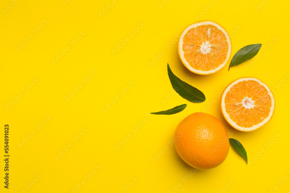 Flat lay with fresh oranges and leaves on color background Flat lay with fresh oranges and leaves on color background