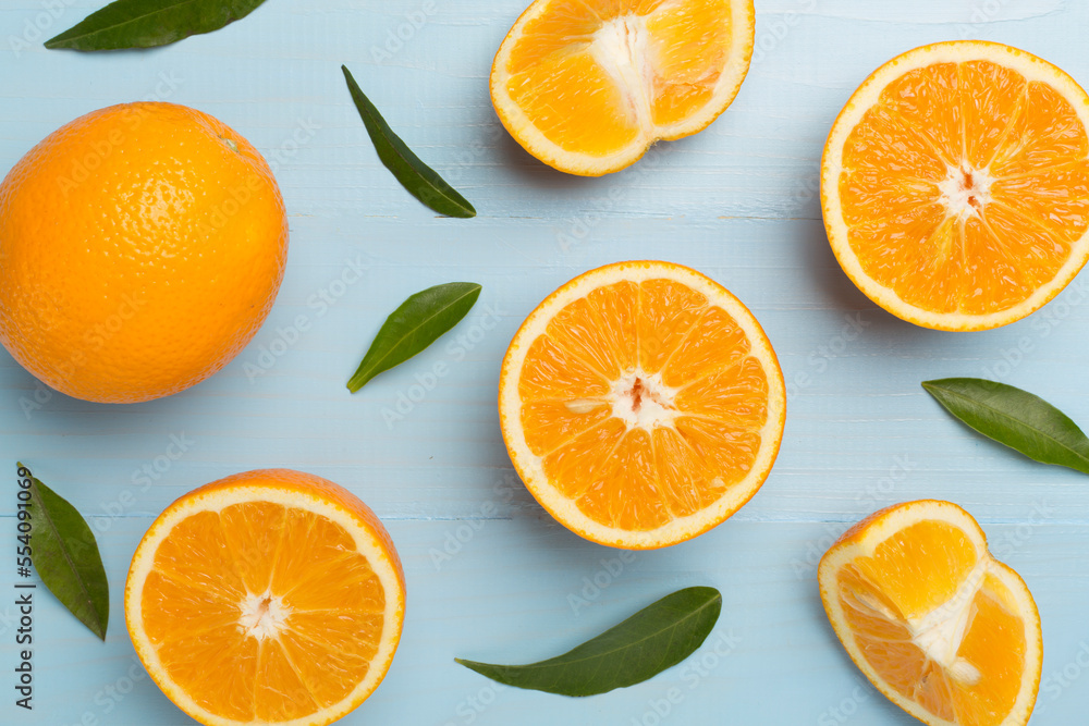 Flat lay with fresh oranges and leaves on wooden background Flat lay with fresh oranges and leaves on wooden background