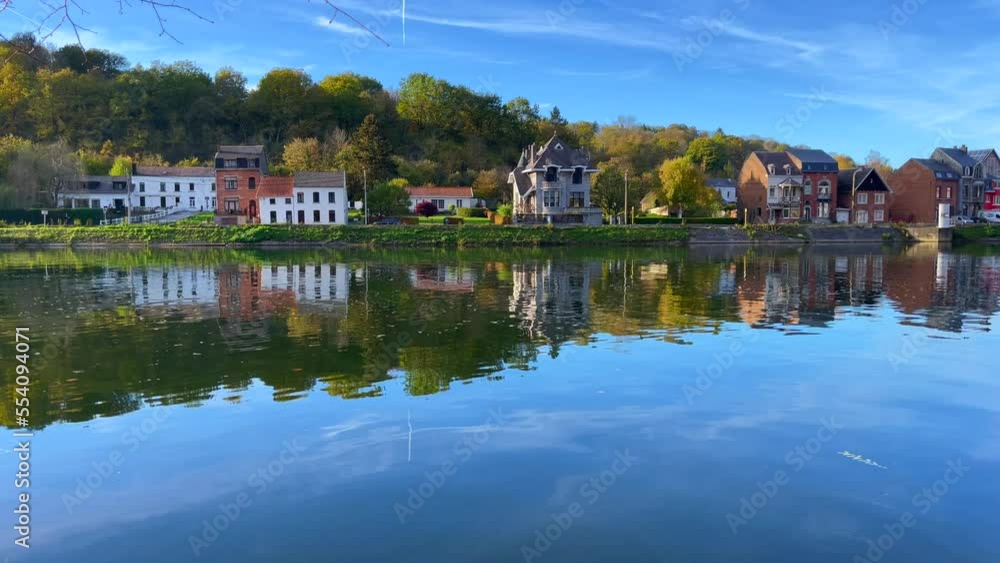 View of old buildings with the reflection on the Meuse river in Dinant, Belgium View of old buildings with the reflection on the Meuse river in Dinant, Belgium