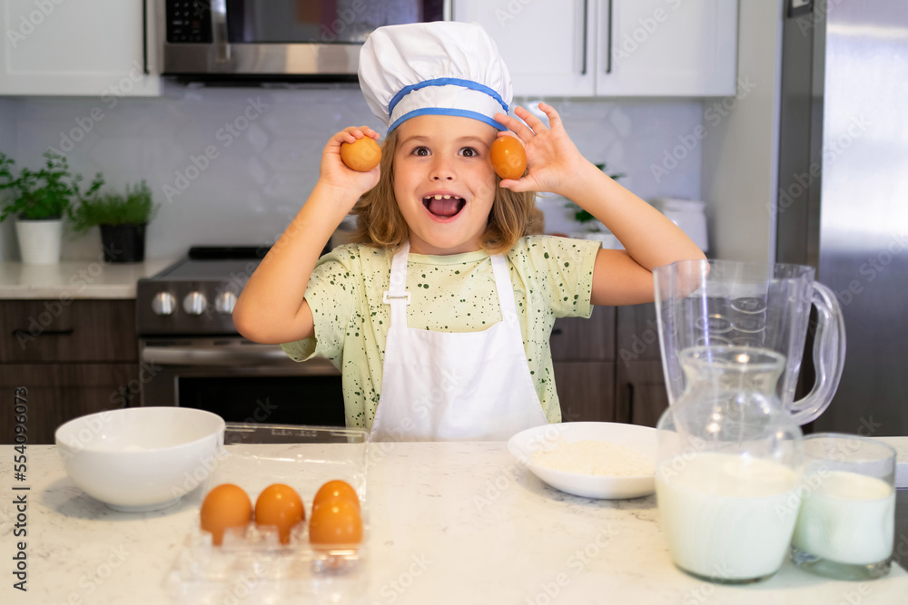 Child chef cook. Funny child stand at kitchen table have fun baking, doing bakery preparing food at home kithen. Healthy food. Little chef preparing healthy meal. Child chef cook. Funny child stand at kitchen table have fun baking, doing bakery preparing food at home kithen. Healthy food. Little chef preparing healthy meal.