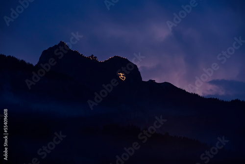 To celebrate the Herz-Jesu, Sacred Heart, festival, the people of the Tannheaim region in Austria climb up the neighbouring mountains and at twilight light fires in religious shapes to acknowledge and