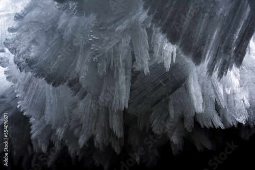 Detail photograph of the giant ice crystals clinging to the walls and ceiling of The Crystal Palace cave.; Greenland. photo
