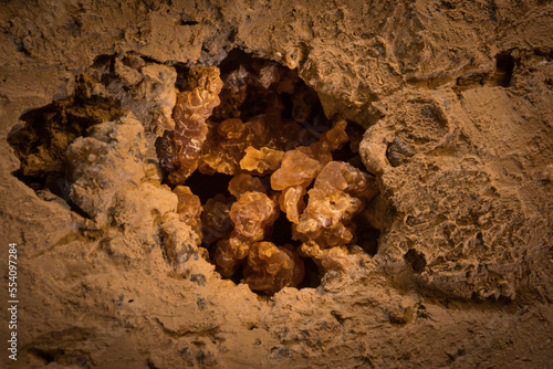 Clean crystals of cryogenic calcite in the drip-hole on the clay cave floor. Drips falling from ca. 15 M made this hole and exposed calcite, Ural Mountains; Russia photo