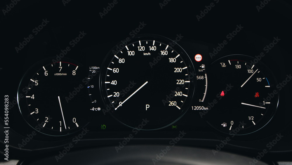 Modern car dashboard with speedometer, tachometer. Car dashboard. Car dashboard details. Modern car interior. The speedometer of a modern