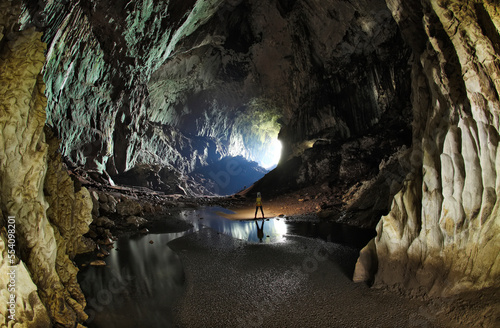 A Mulu Cave Project expedition member adds scale to a massive cave passage in Deer Cave. photo