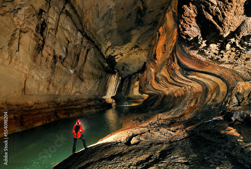 A Mulu Cave Project expedition member progresses downstream in Clearwater River Cave.