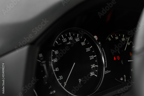 Modern car dashboard with speedometer, tachometer. Car dashboard. Car dashboard details. Modern car interior. The speedometer of a modern