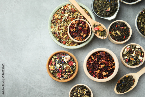 Many different herbal teas on grey table, flat lay
