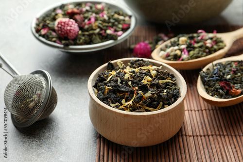 Different herbal teas on grey table  closeup