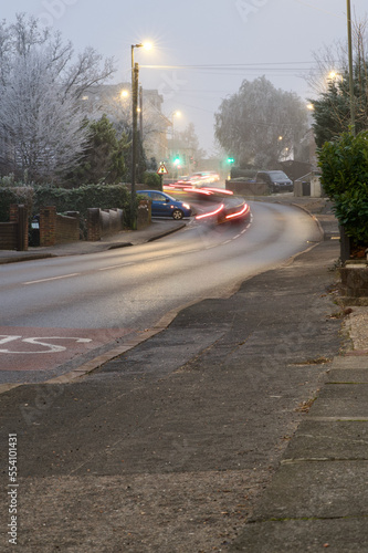 Motion blur lights on cars queuing up a hill on a frosty winter evening