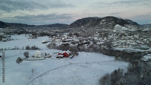 Sunset over Norwegian coastal landscape. Winter, mountains and fjord.