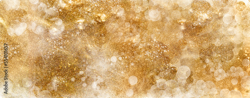 Golden Christmas background banner with festive shiny sparkles and twinkling bokeh. Gold glitter festive abstract background