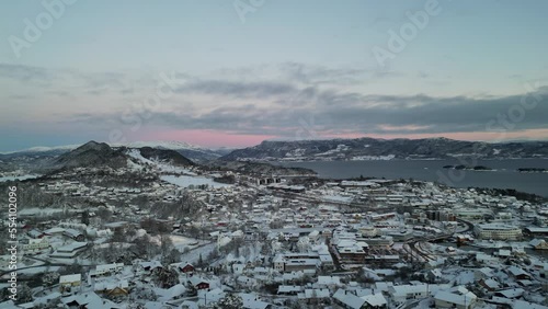Sunset over Norwegian coastal landscape. Winter, mountains and fjord.
