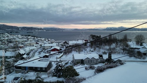 Sunset over Norwegian coastal landscape. Winter, mountains and fjord.