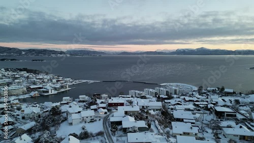 Sunset over Norwegian coastal landscape. Winter, mountains and fjord.