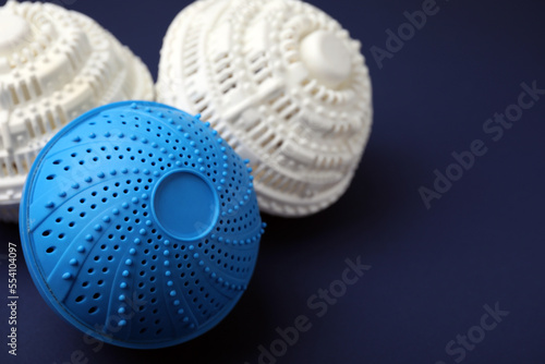Laundry dryer balls on dark blue background, closeup. Space for text