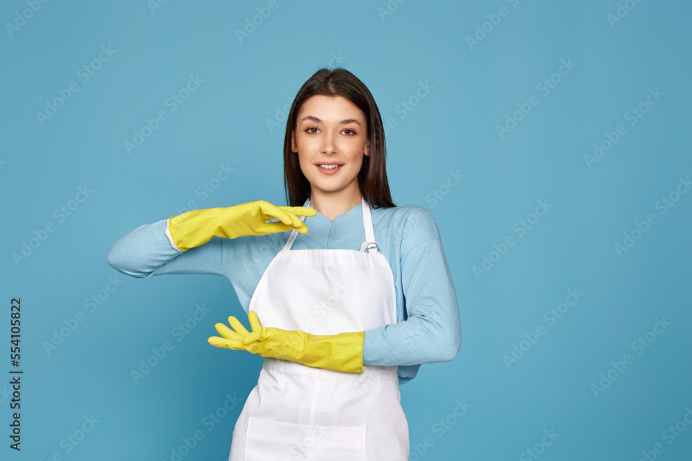 woman in cleaner apron showing measure symbol gesture woman in cleaner apron showing measure symbol gesture
