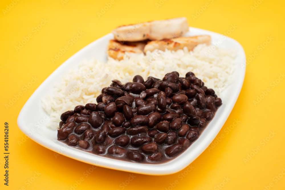 Healthy food with chicken breast, beans and rice on a white plate. Healthy food with chicken breast, beans and rice on a white plate.