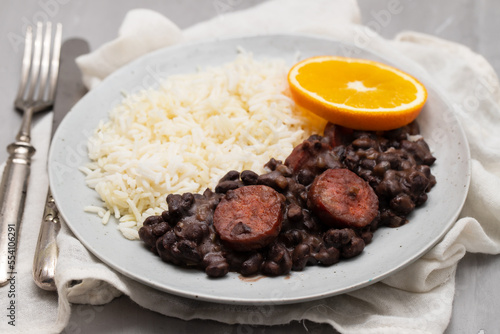 Typical brazilian food beans with sausages and rice Feijoada on white dish