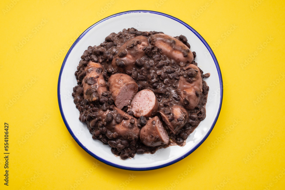 black beans stew with sausages on a white dish black beans stew with sausages on a white dish