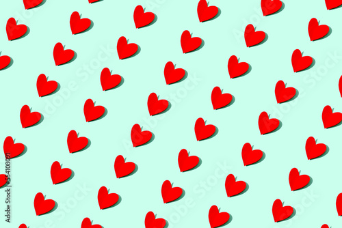 st valentine's day red hearts pattern on light green background