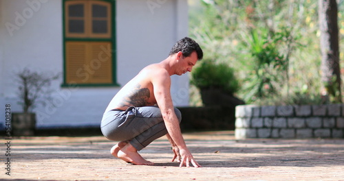 Man dusting off hands by cleaning with pants, preparing to exercise photo