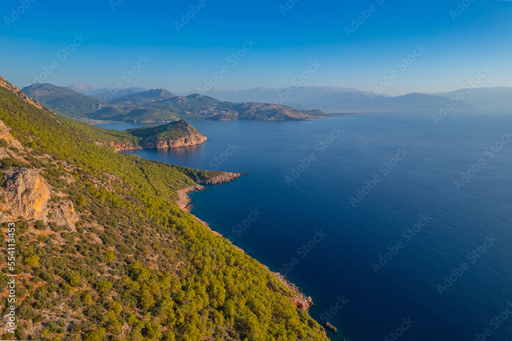 Lycian Way from forest and sea in Antalya, Turkey Aerial top view. Concept beautiful summer landscape at sunset from drone