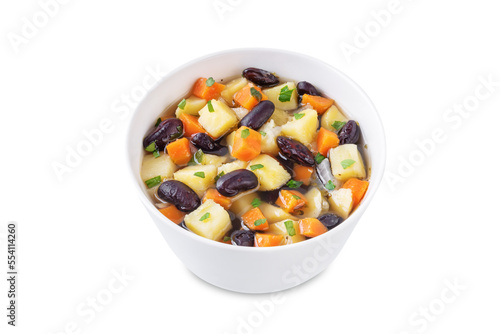 Kidney beans potato carrot vegan soup in a bowl on a white isolated background