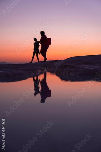 A fun family by the lake at sunset  reflection and silhouette  golden hours  Pamukkale travertines - Denizli