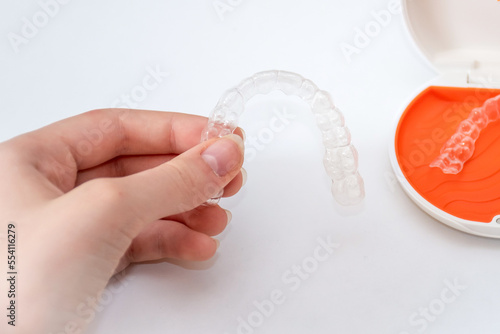 Transparent aligners retainers in a storage case. Invisible braces. Clear teeth straighteners. Orthodontic plastic bracers system photo