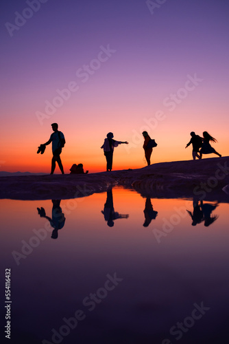 A fun family by the lake at sunset  reflection and silhouette  golden hours  Pamukkale travertines - Denizli