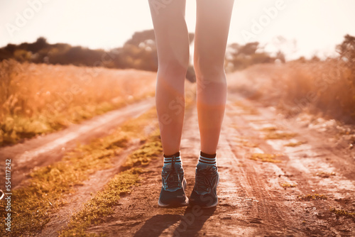 Girl is running, jogging outdoor at sunset.