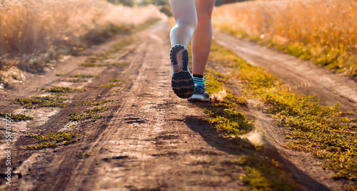 Girl is running, jogging outdoor at sunset.