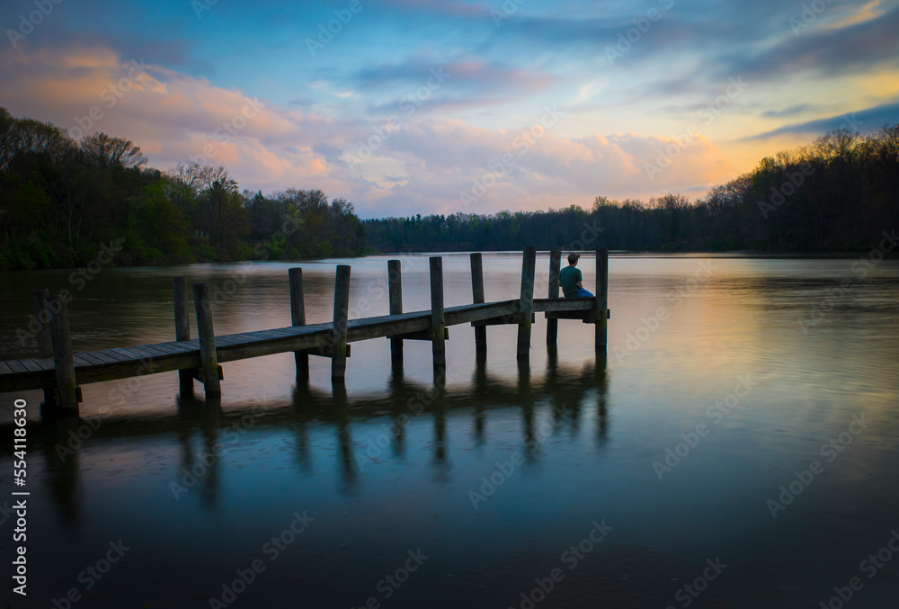 A man sits on a dock in Youngtown, Ohio