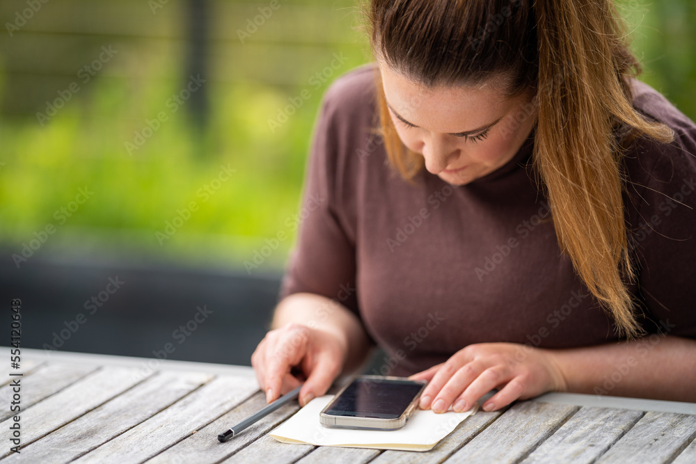 girl working on her phone, working remote in the country girl working on her phone, working remote in the country
