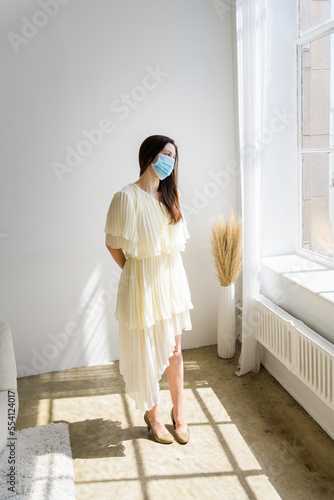 Girl looking out a large window