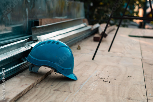 blue safety helmet abandoned in a incomplete construction photo