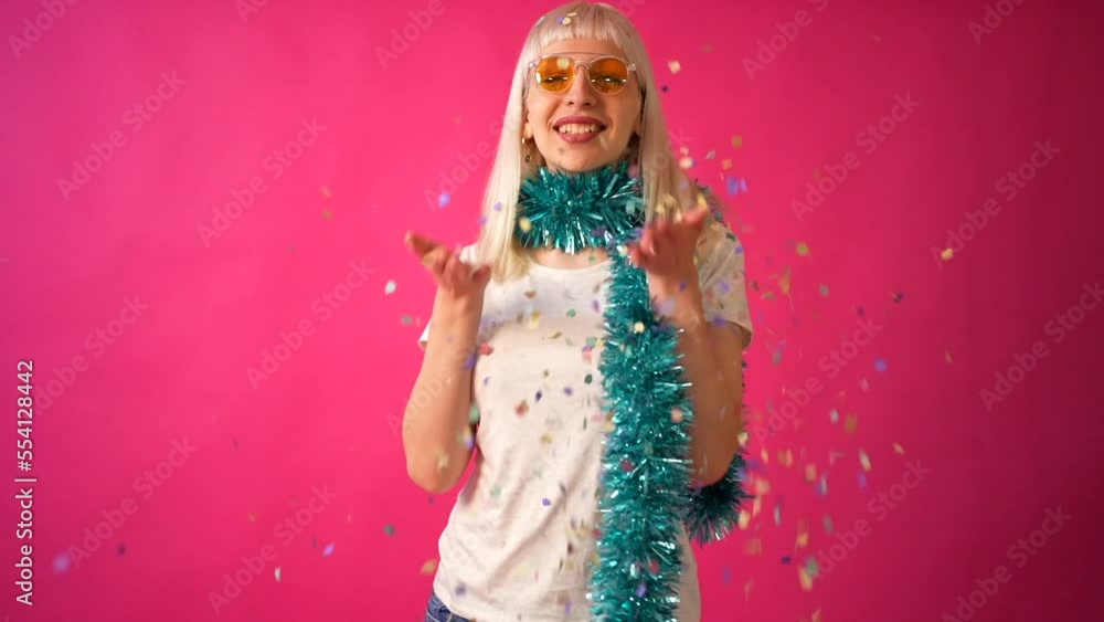 Confetti fashion party with sunglasses, blonde caucasian girl on pink background studio Confetti fashion party with sunglasses, blonde caucasian girl on pink background studio