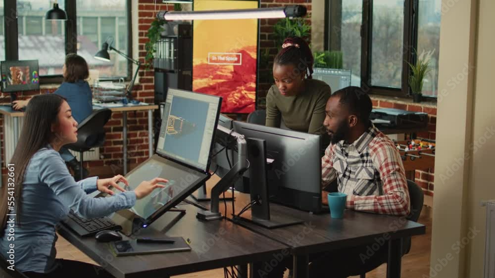 African american team of people looking at cad software on pc, analyzing manufacturing interface with 3d infographics. Man and woman working on industry development in creative agency. African american team of people looking at cad software on pc, analyzing manufacturing interface with 3d infographics. Man and woman working on industry development in creative agency.