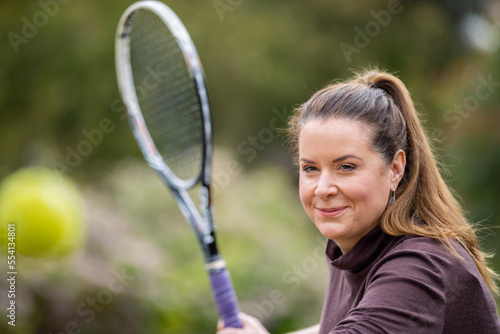 close up of a beautiful girl hitting tennis balls