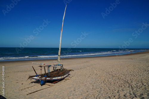 Jangada fishing boats, typical in northeastern Brazil and equipped with sails in the evening sky on the Atlantic coast near the city Canoa Quebrada, municipality Aracati, state of Ceara, Brazil.